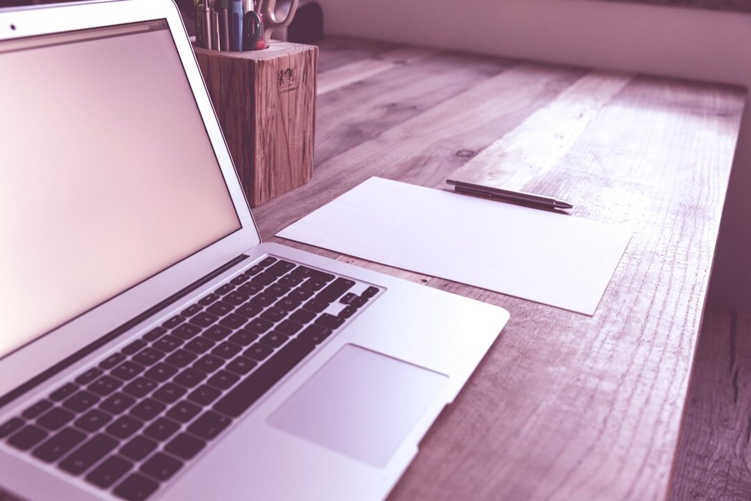 Modern workspace with laptop and notebook in soft ambient light